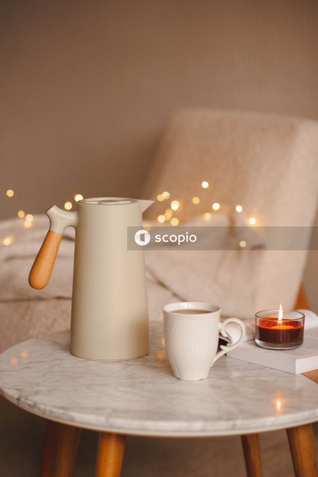 White ceramic pitcher beside white ceramic mug on table