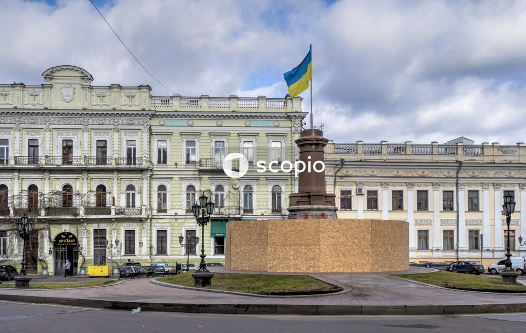 White concrete building with flags on top