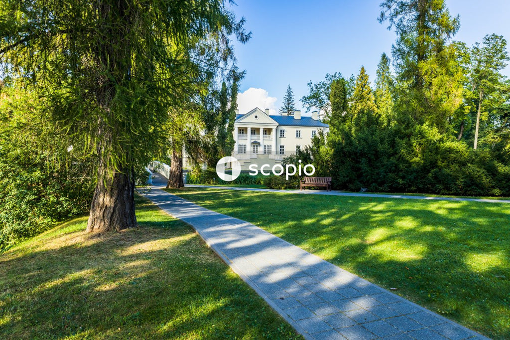 White concrete house near green grass field