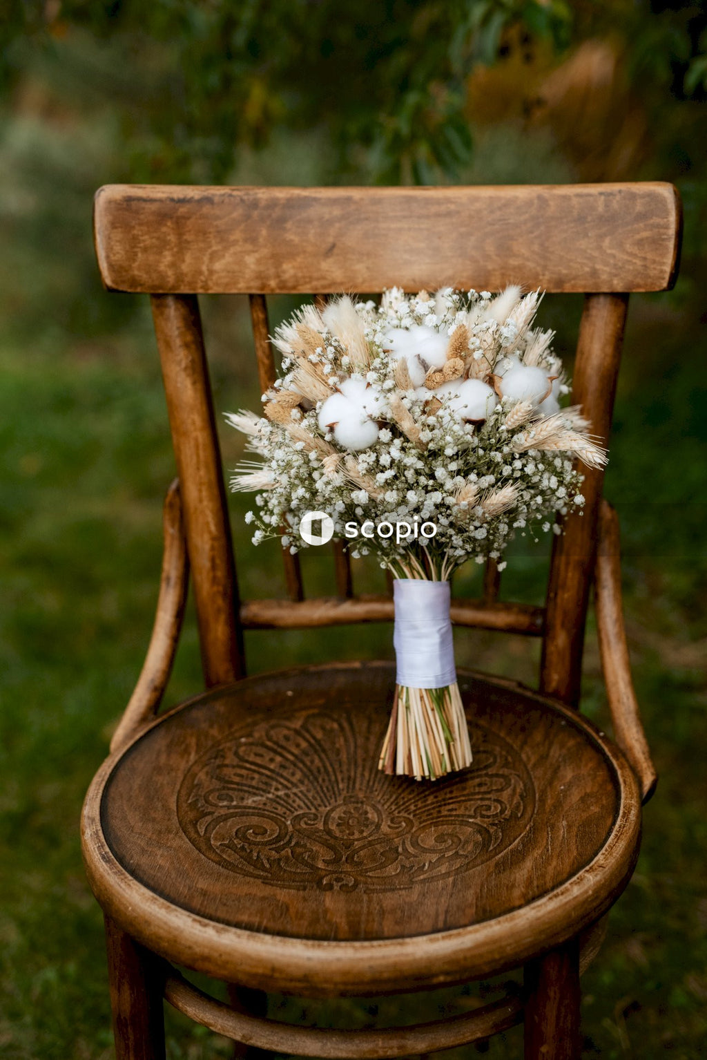 White flowers on brown wooden chair