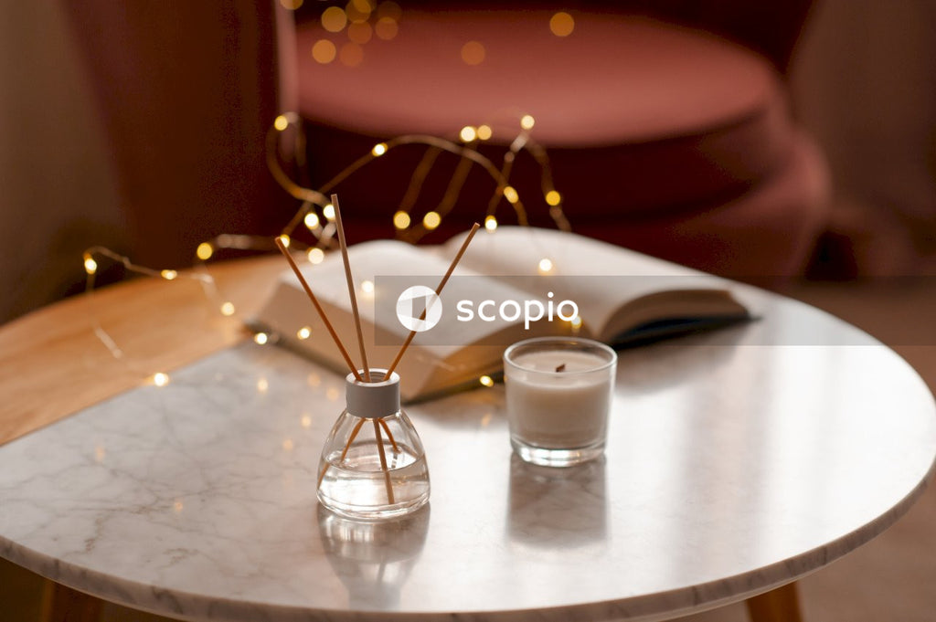 White pillar candle on silver round table
