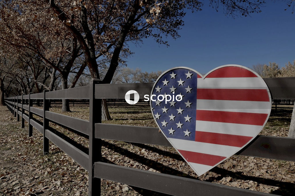 White red and blue heart shaped decor on brown wooden fence