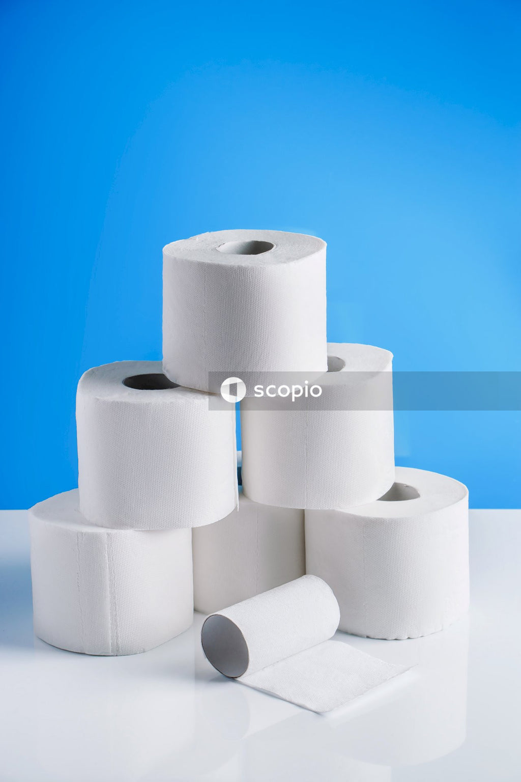 White tissue roll on blue surface
