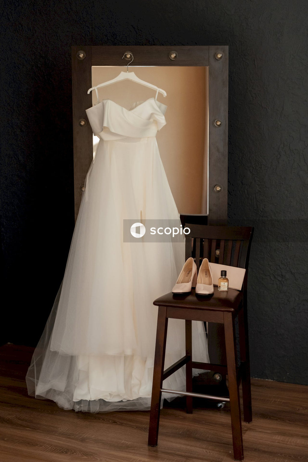 White wedding dress on brown wooden table