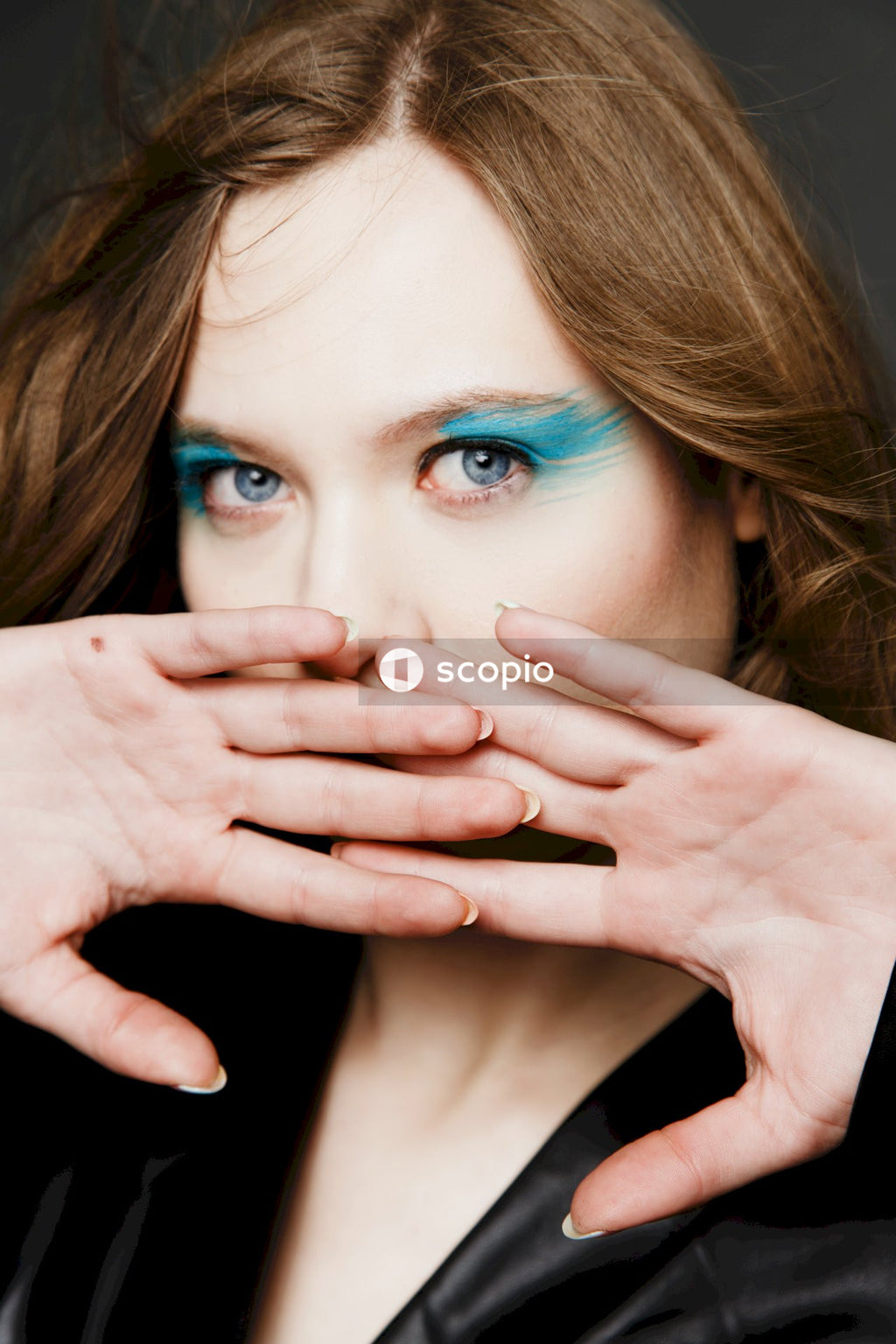 Woman covering her face with her hand