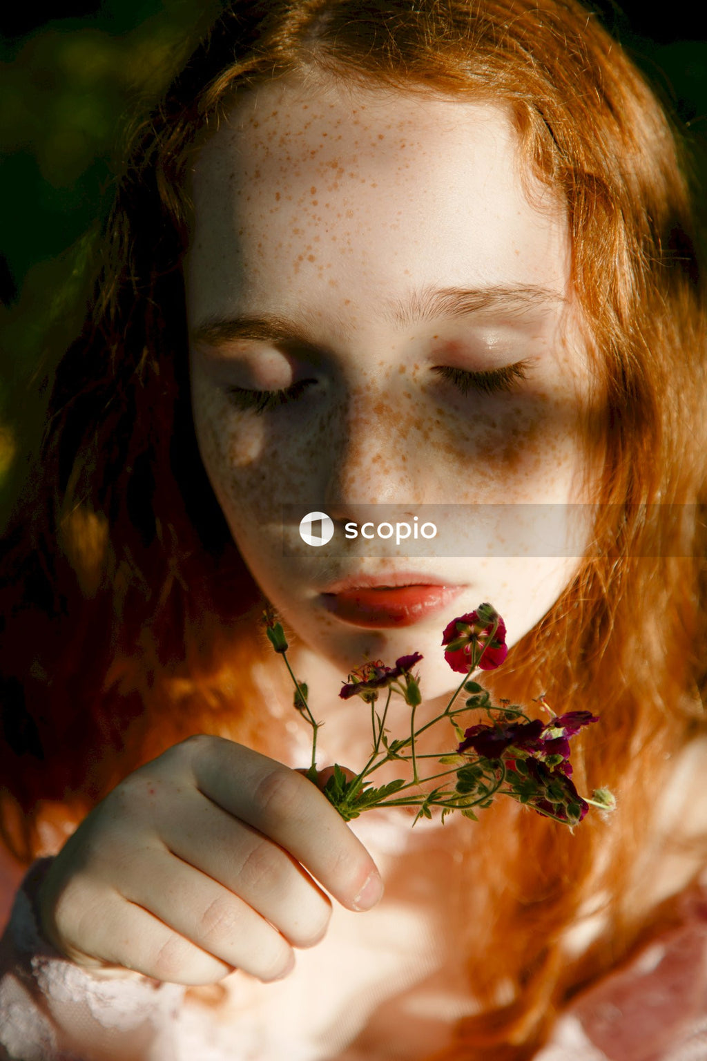 Woman holding red flower