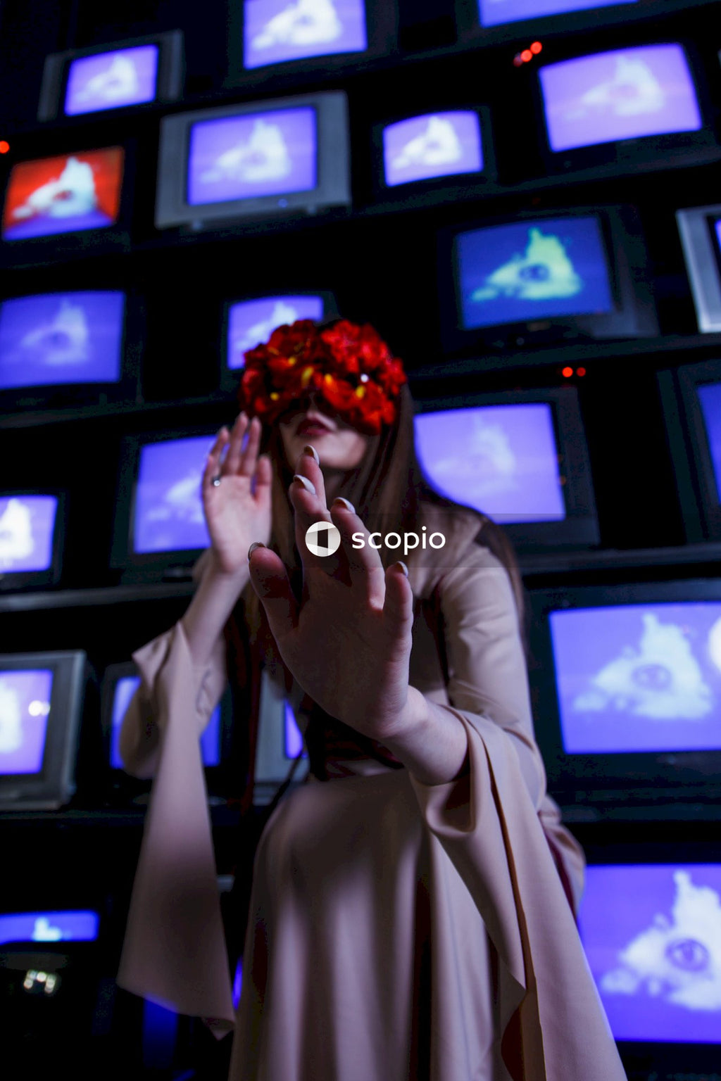 Woman in beige robe covering her face with her hands