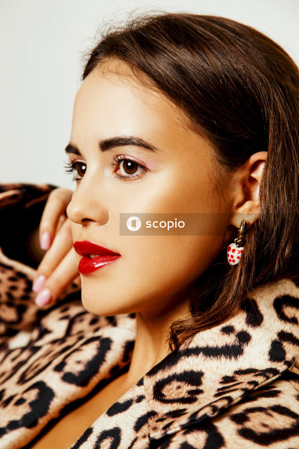 Woman in black and brown leopard print shirt