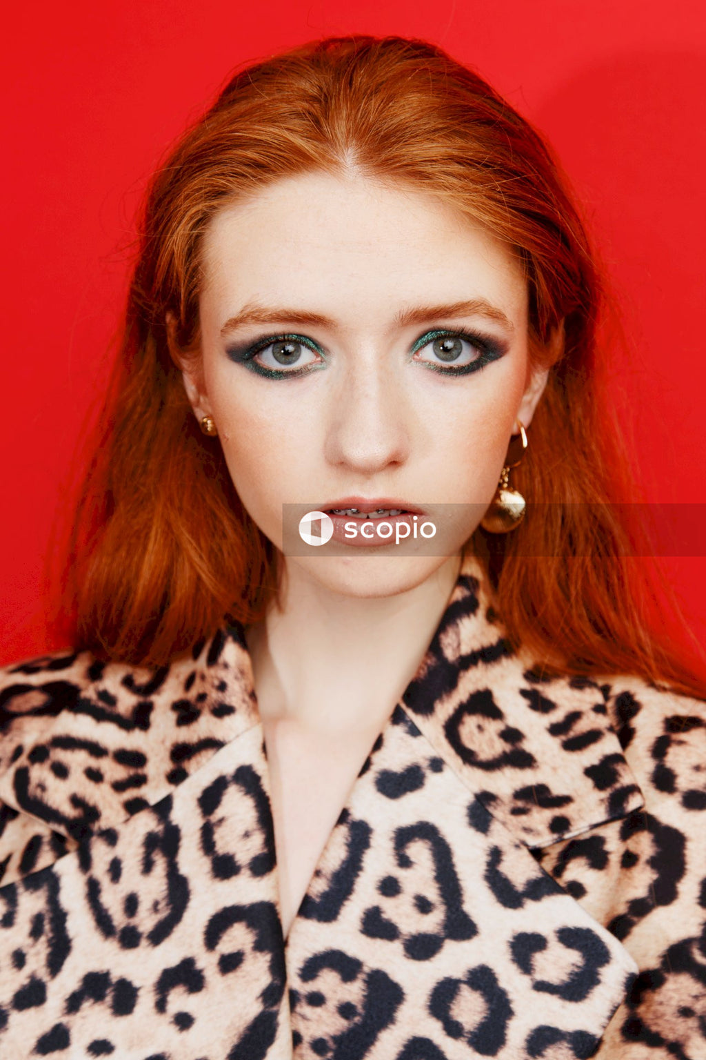 Woman in black and white leopard print coat
