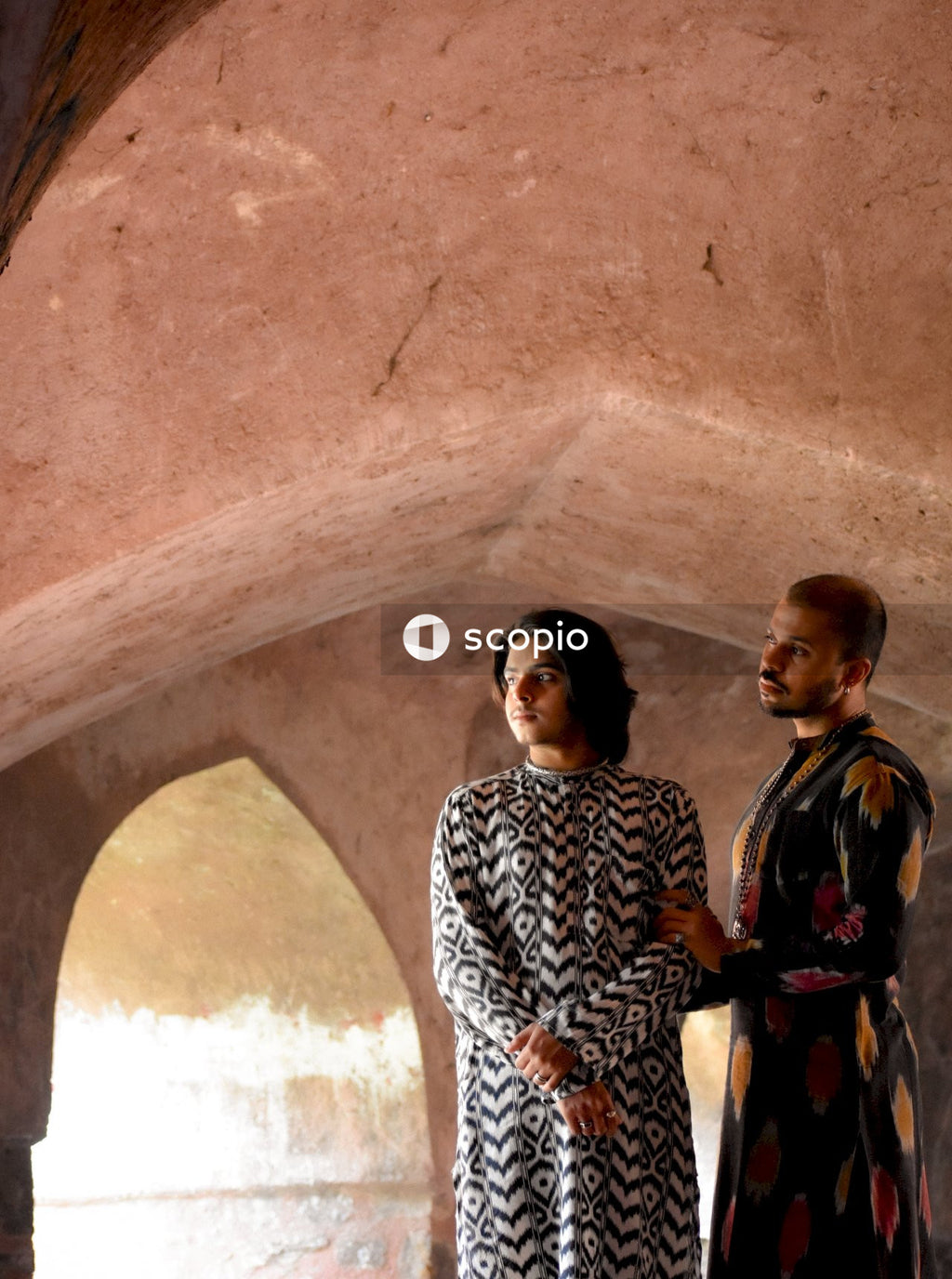Two genderqueer men having romantic moments in an Indian ancient building