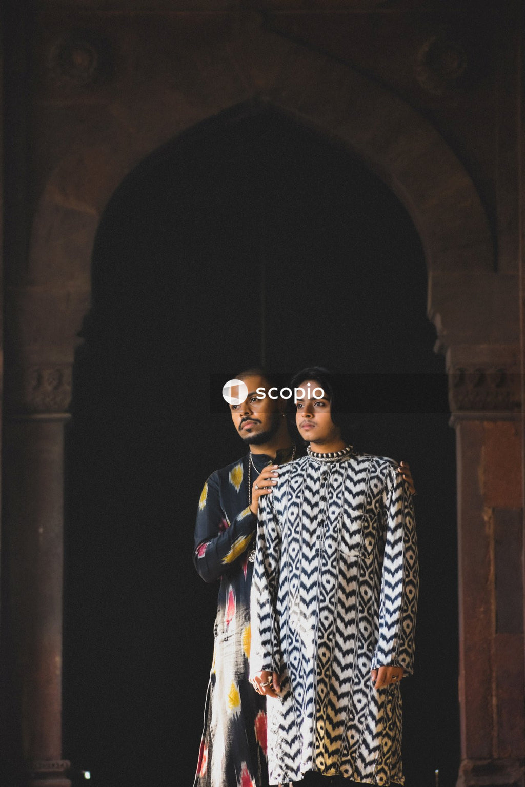 Two genderqueer men having romantic moments in an Indian ancient building