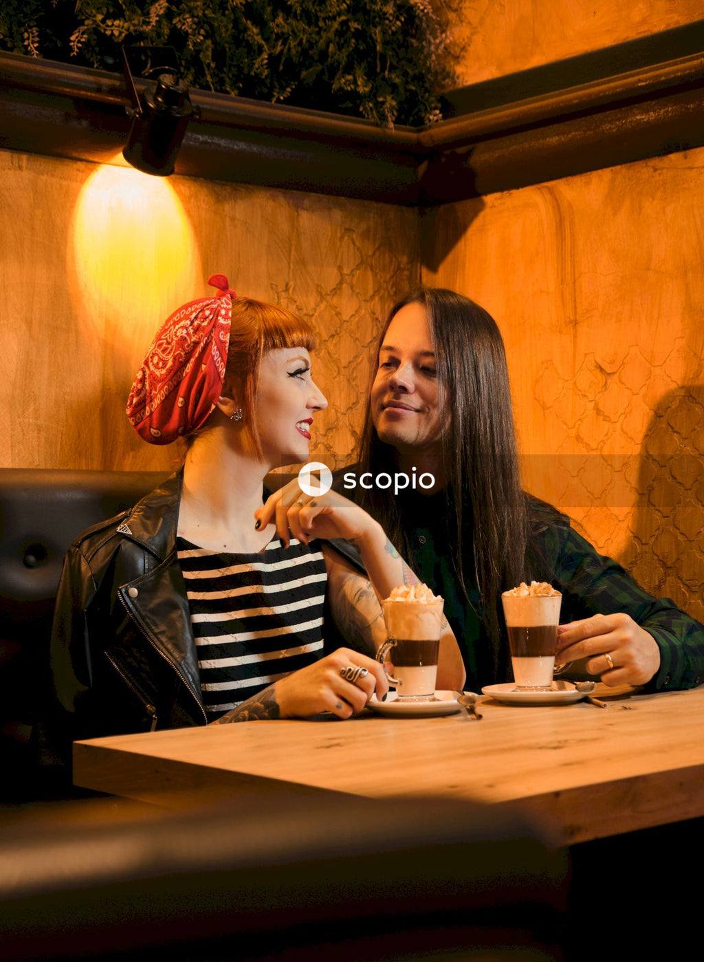Woman in black and white striped long sleeve shirt sitting beside woman in black and white