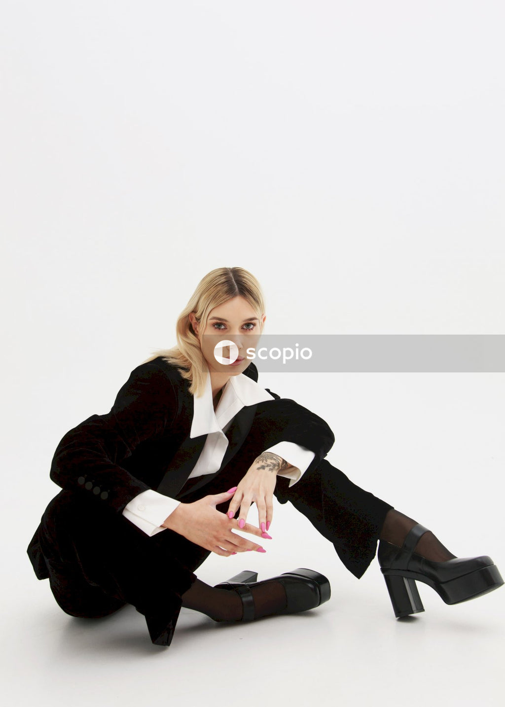 Woman in black blazer and black pants sitting on chair