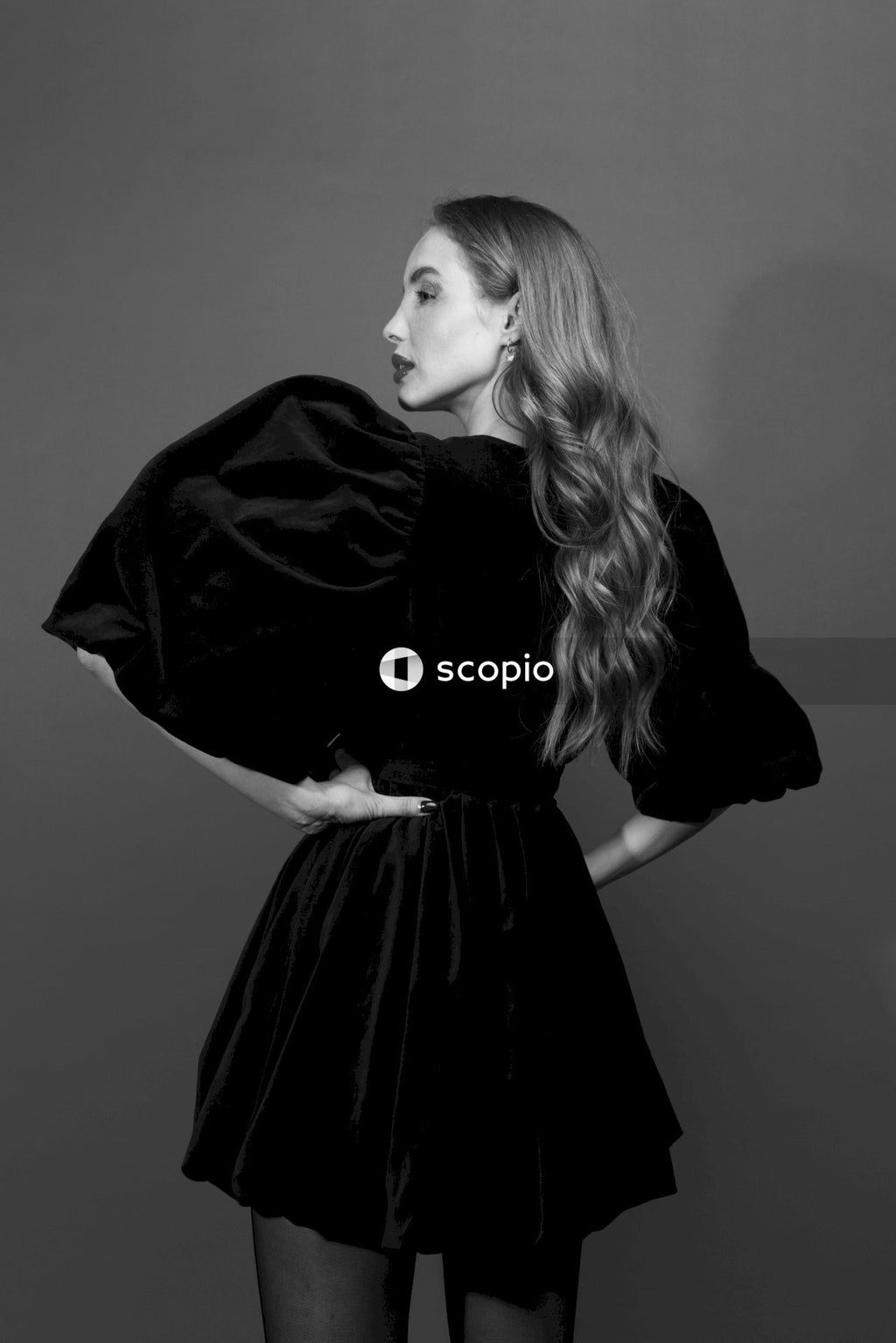 Woman in black dress in grayscale