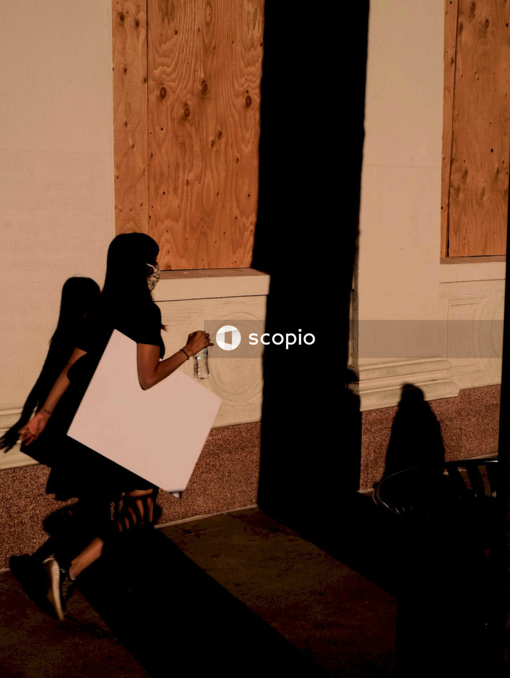 Woman in black dress sitting on floor