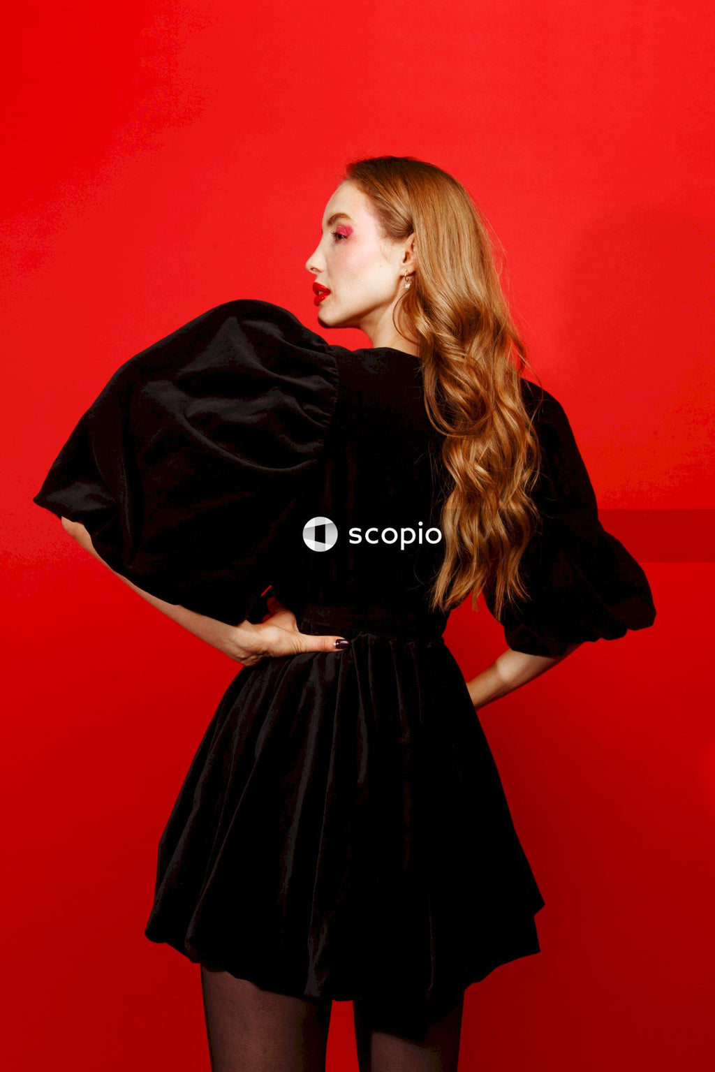 Woman in black dress standing