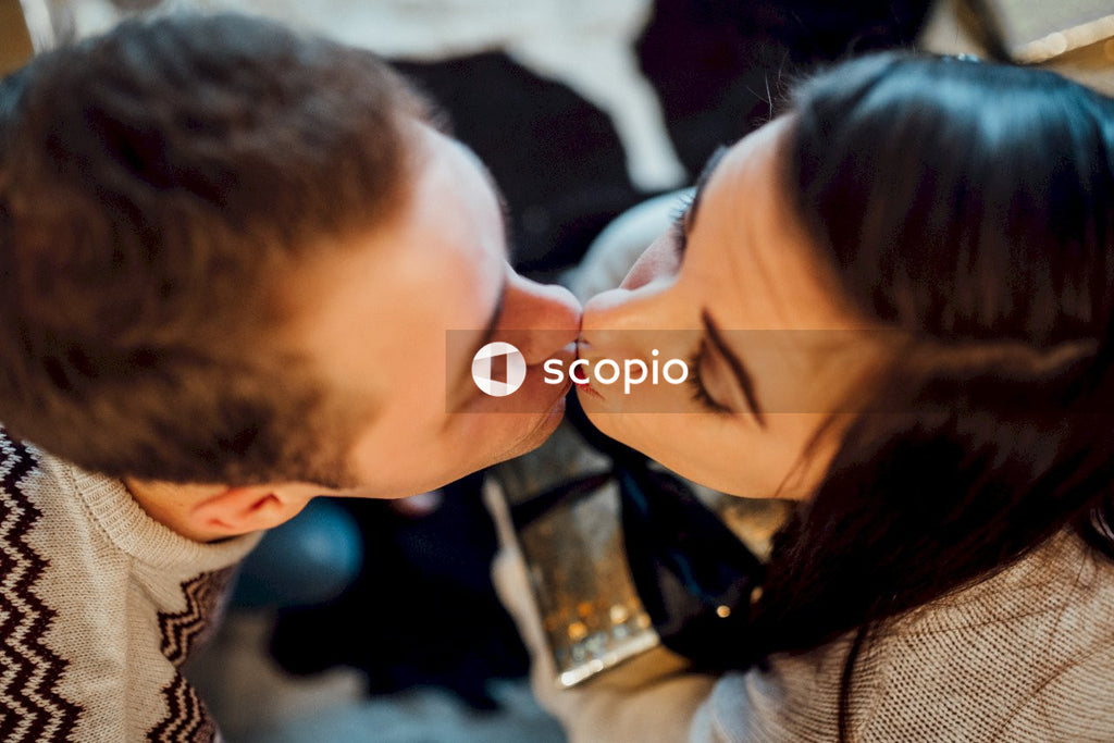 Woman in black framed eyeglasses kissing mans cheek