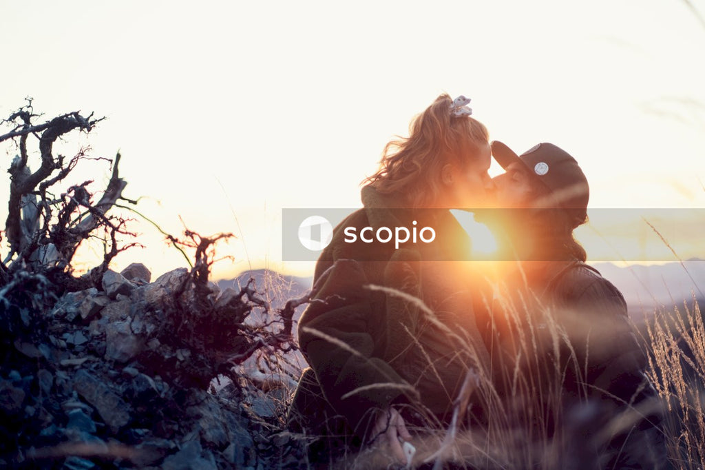 Man and woman kissing outdoor during golden hours