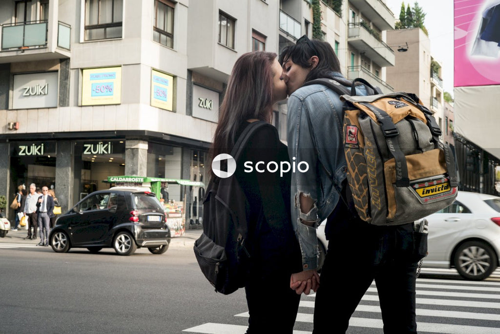 Two women kissing on street