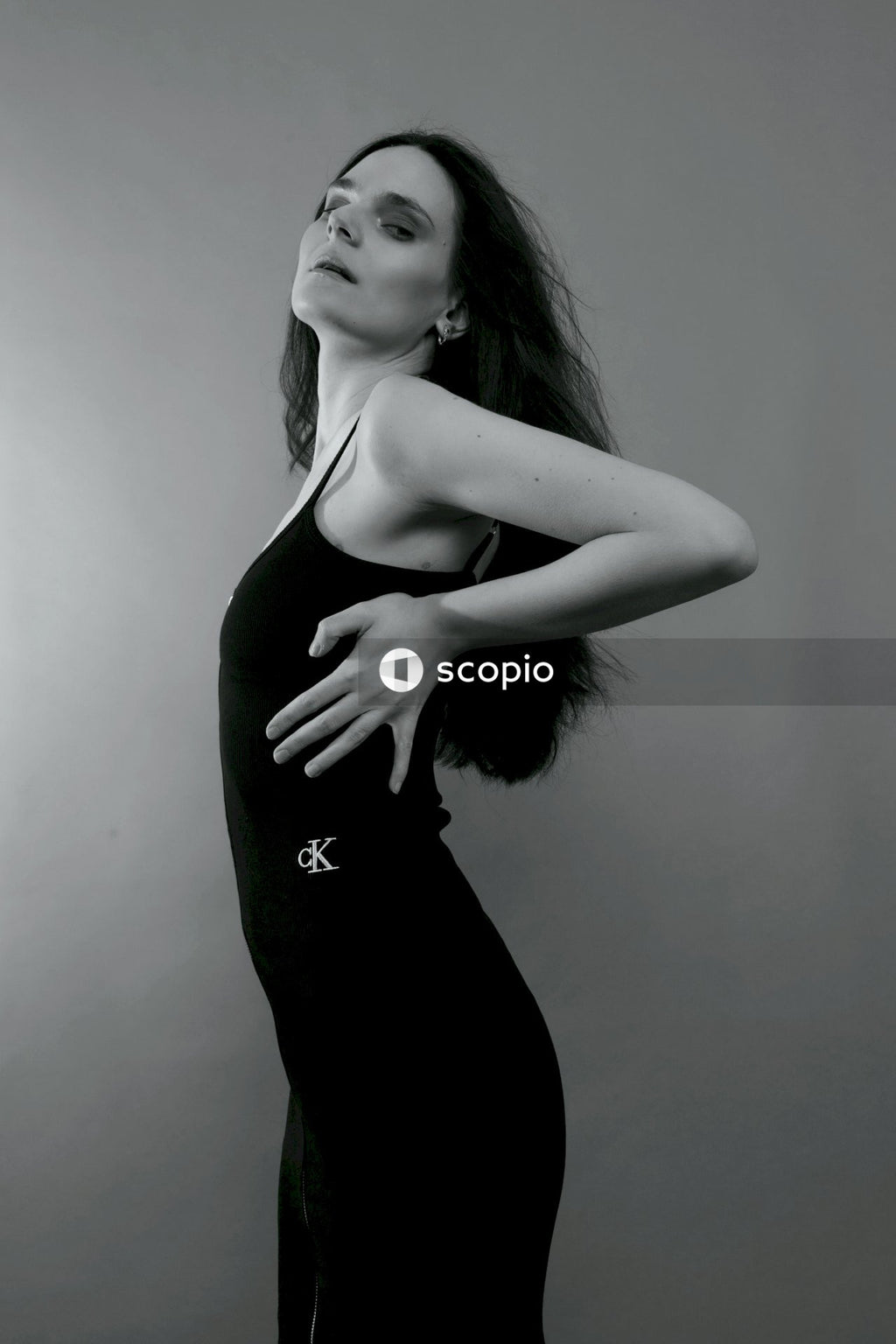 Woman in black spaghetti strap dress