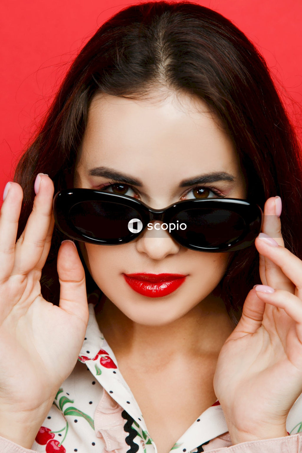 Woman in black sunglasses and red lipstick