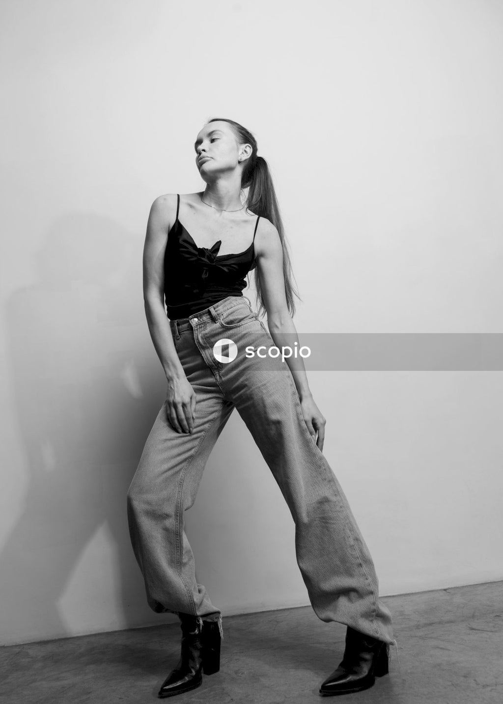 Woman in black tank top and denim jeans