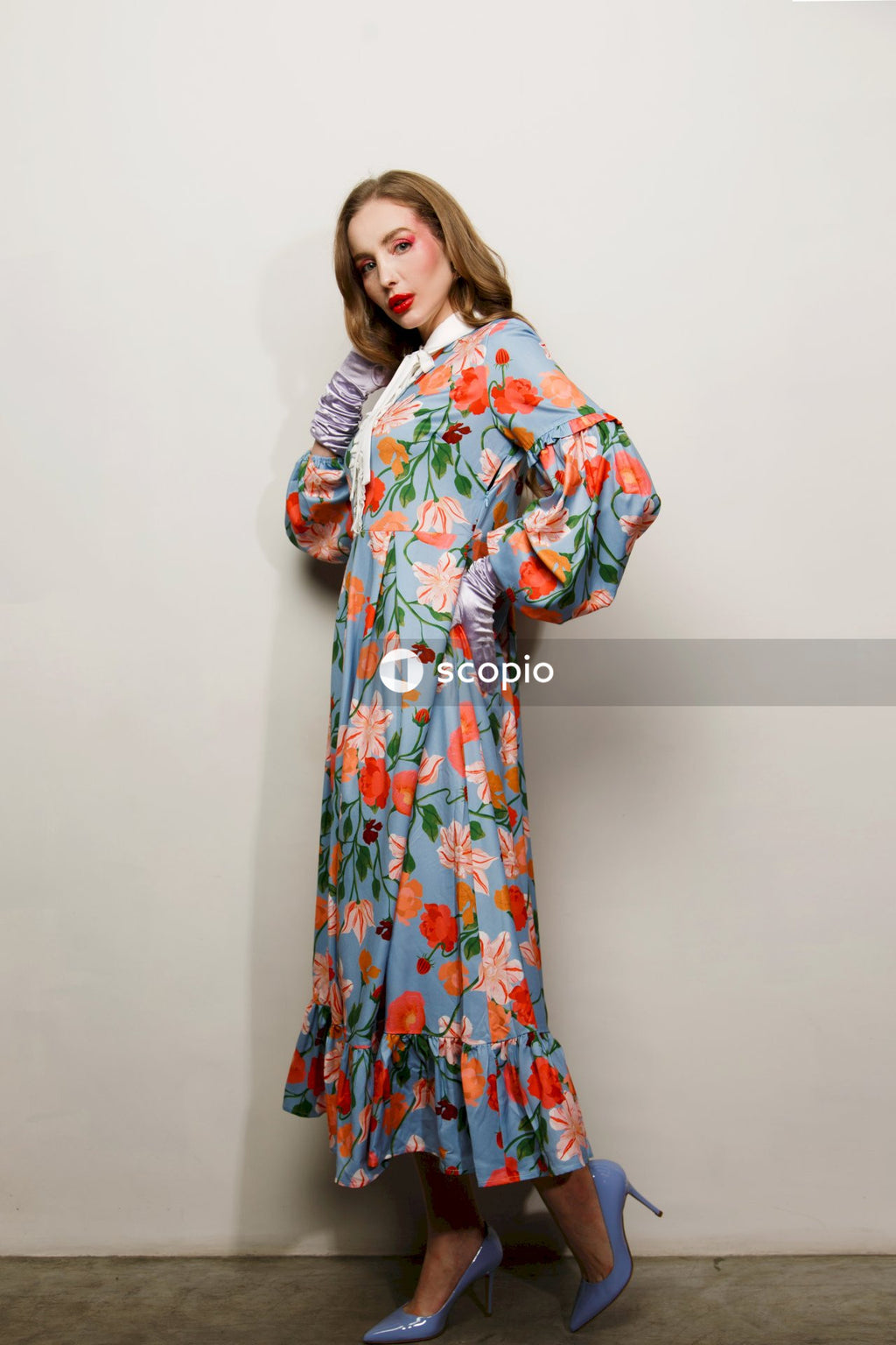Woman in blue and red floral dress