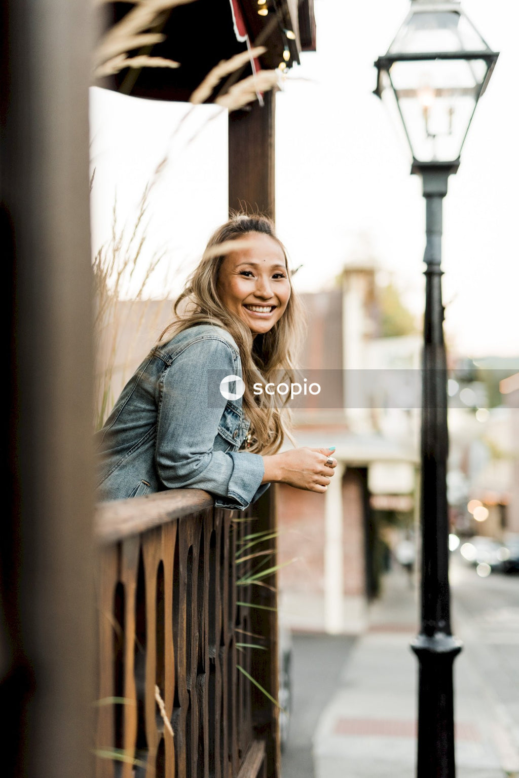 Woman in blue denim jacket smiling