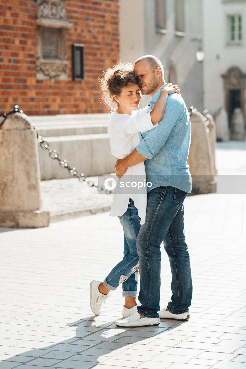 Woman hugging a man on street