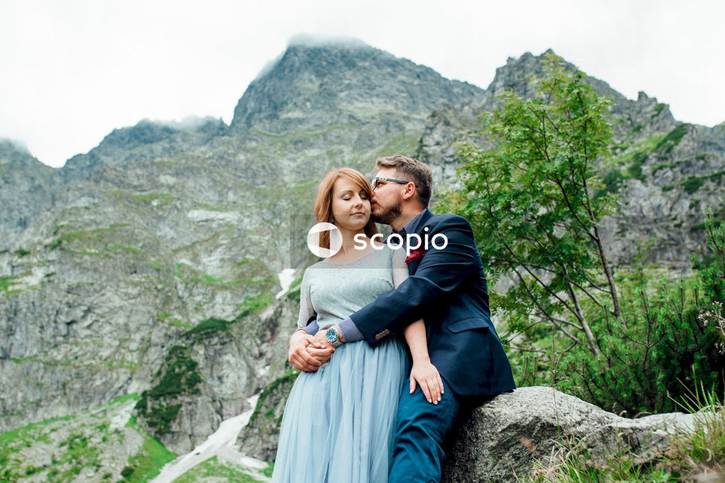 Woman in blue dress hugging woman in black jacket