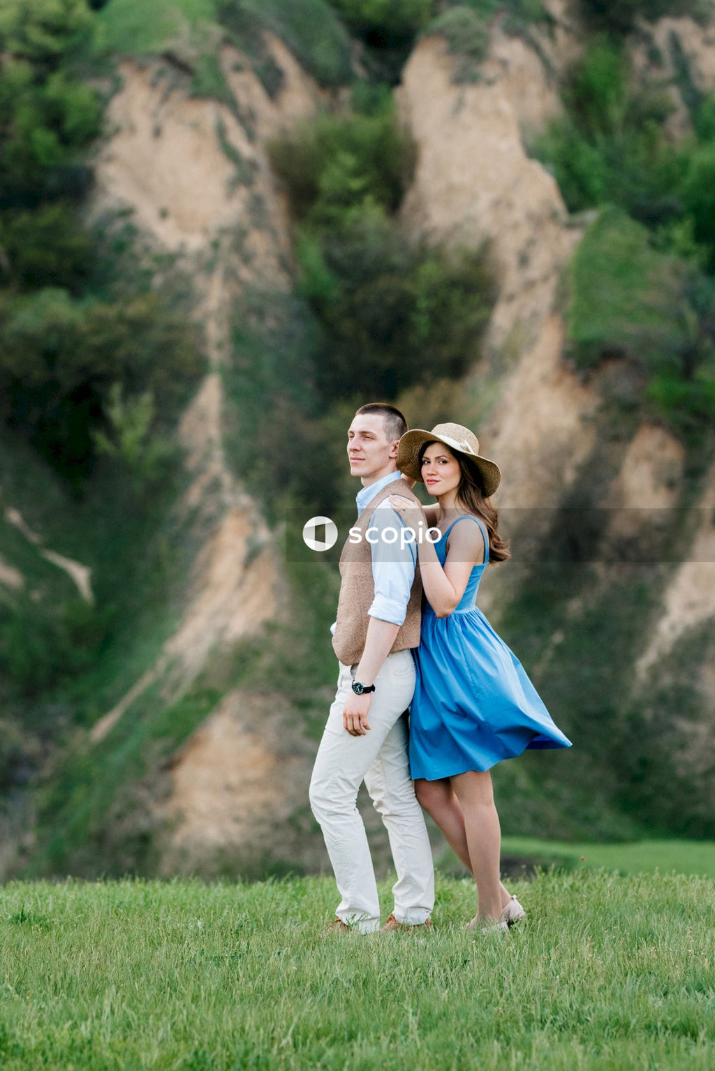 Woman in blue dress hugging woman in white dress