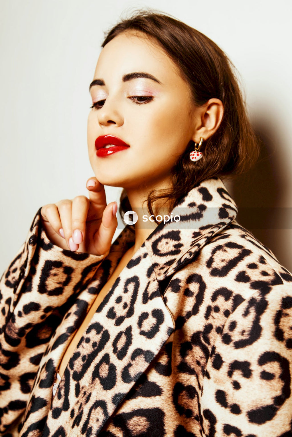 Woman in brown and white leopard print coat