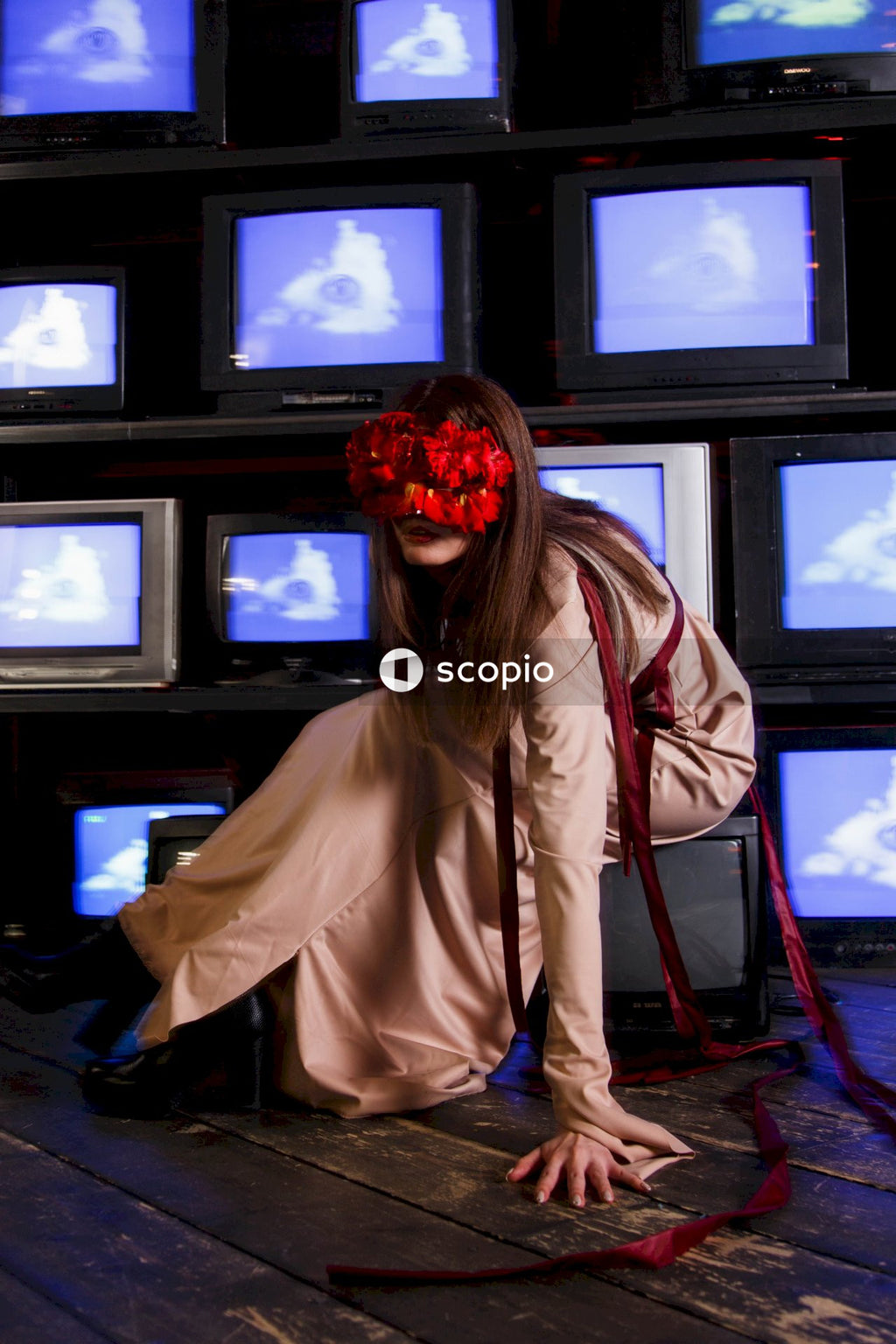 Woman in brown coat standing near black crt tv