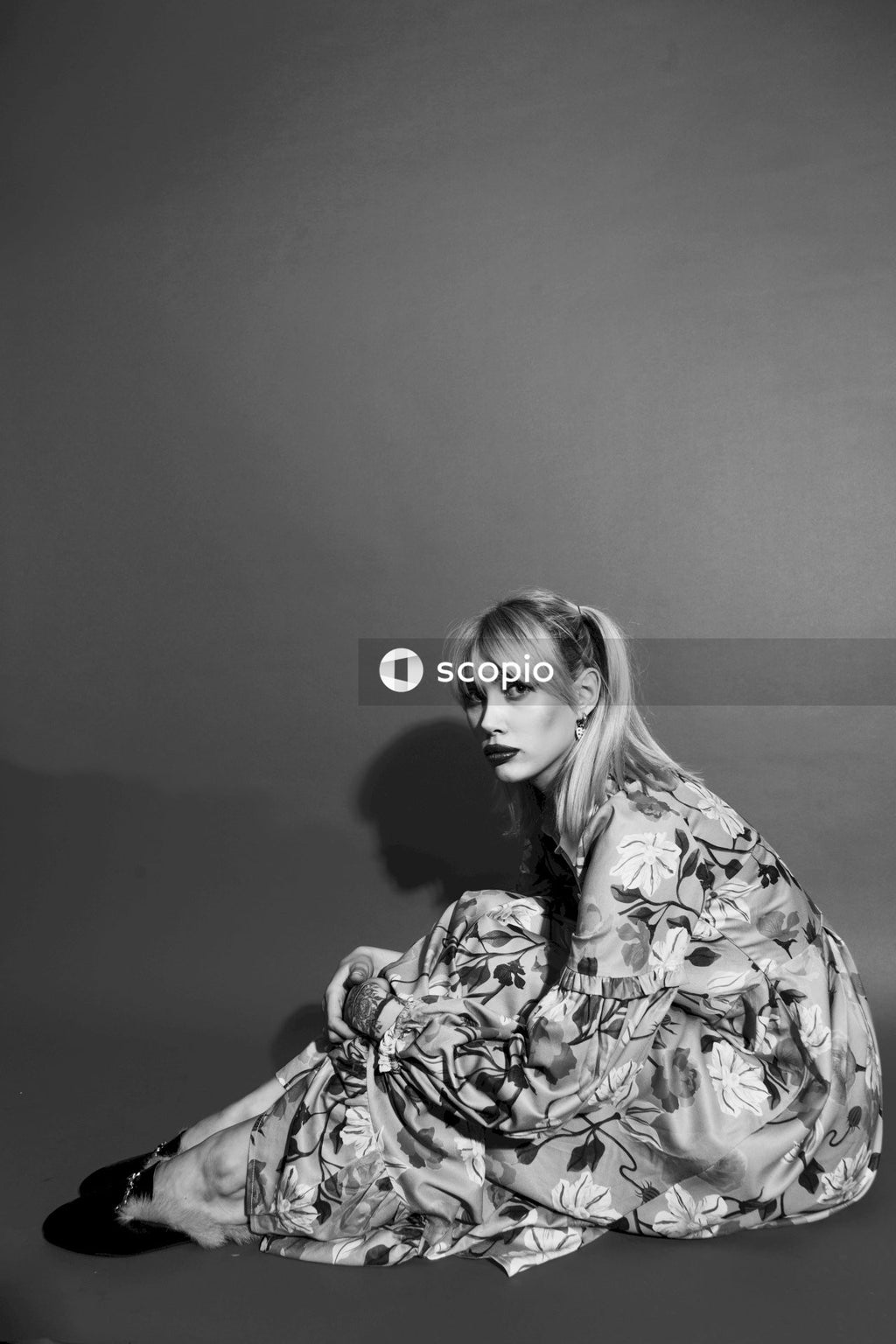 Woman in floral dress sitting on chair