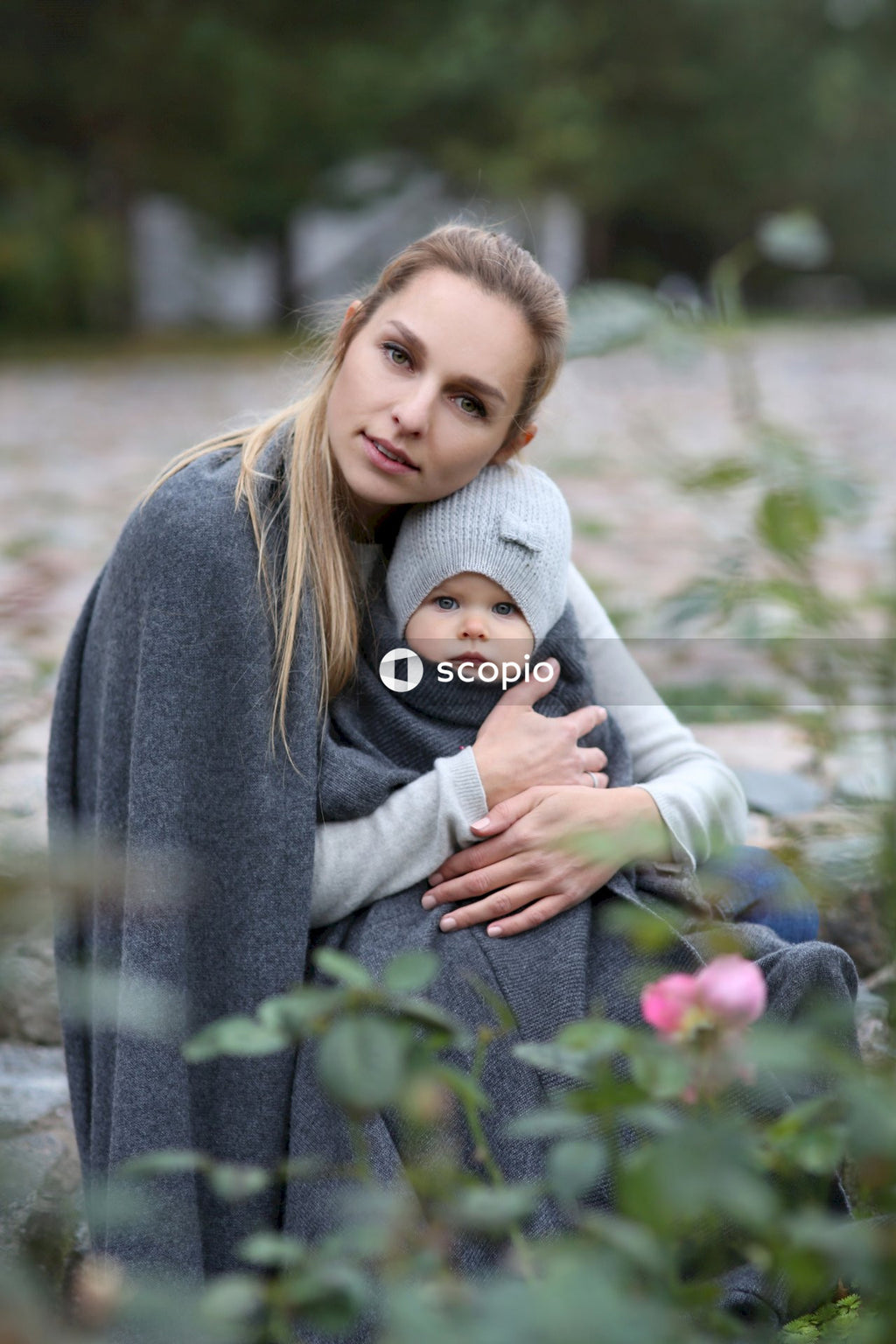 Woman in gray sweater hugging woman in gray sweater