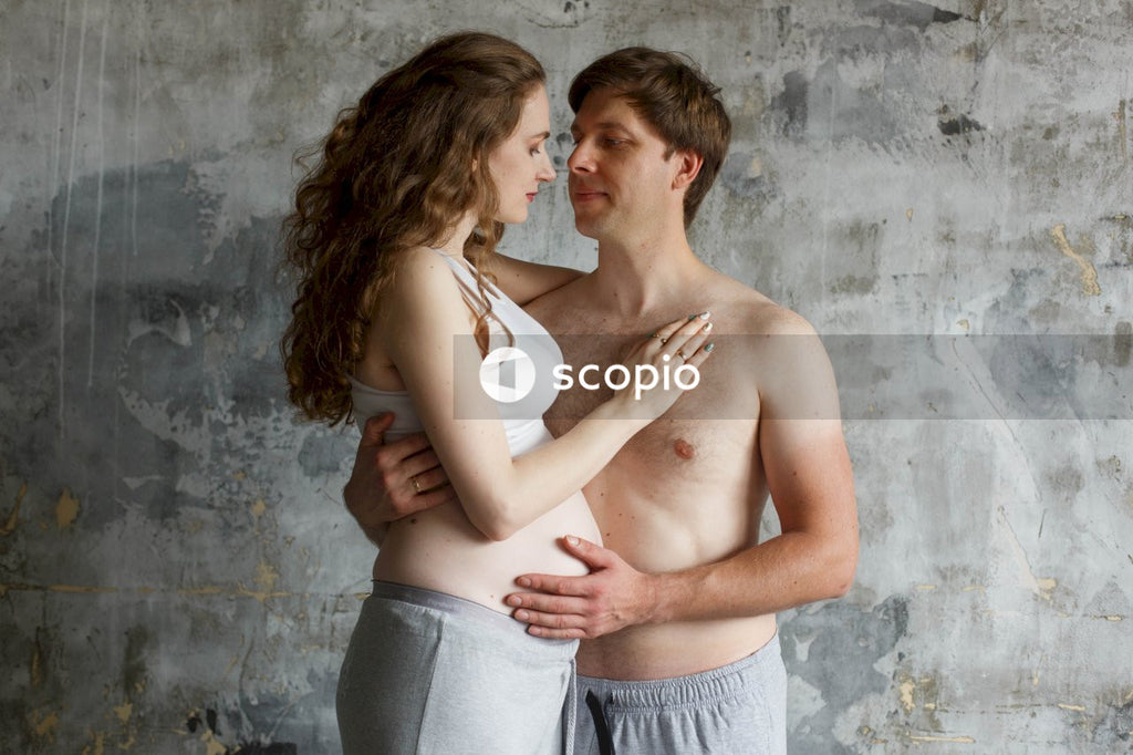 Woman in gray tank top hugging man