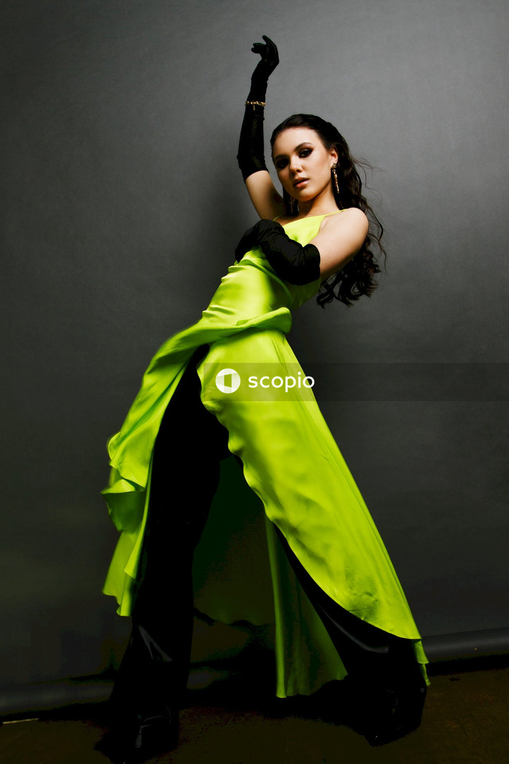 Woman in green dress holding her hair
