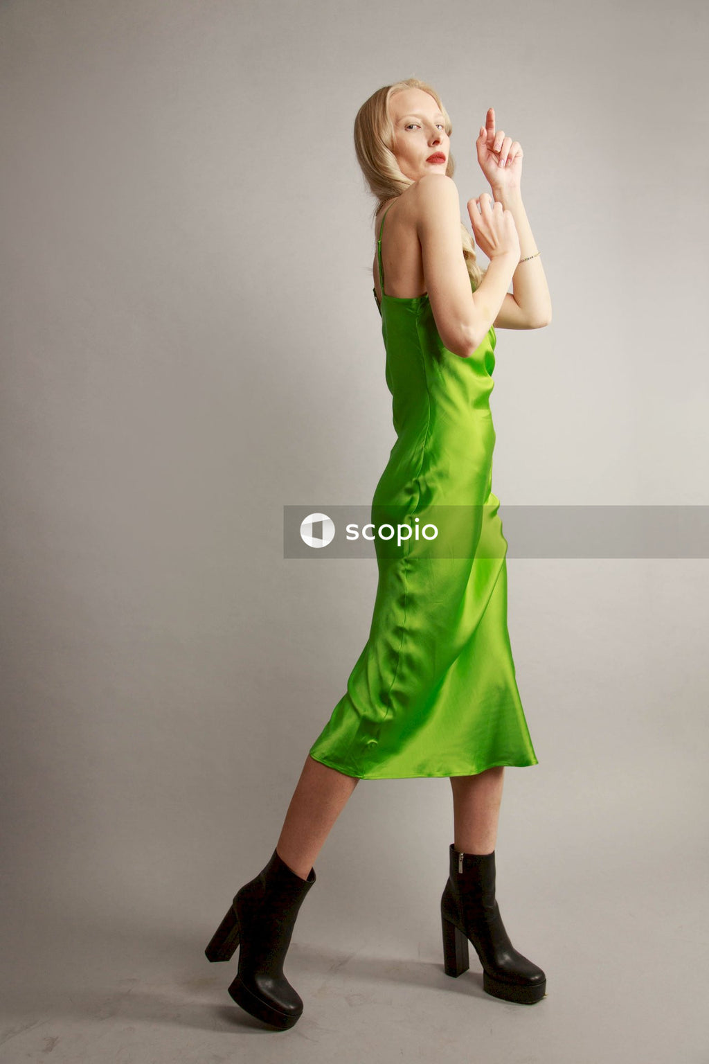 Woman in green sleeveless dress