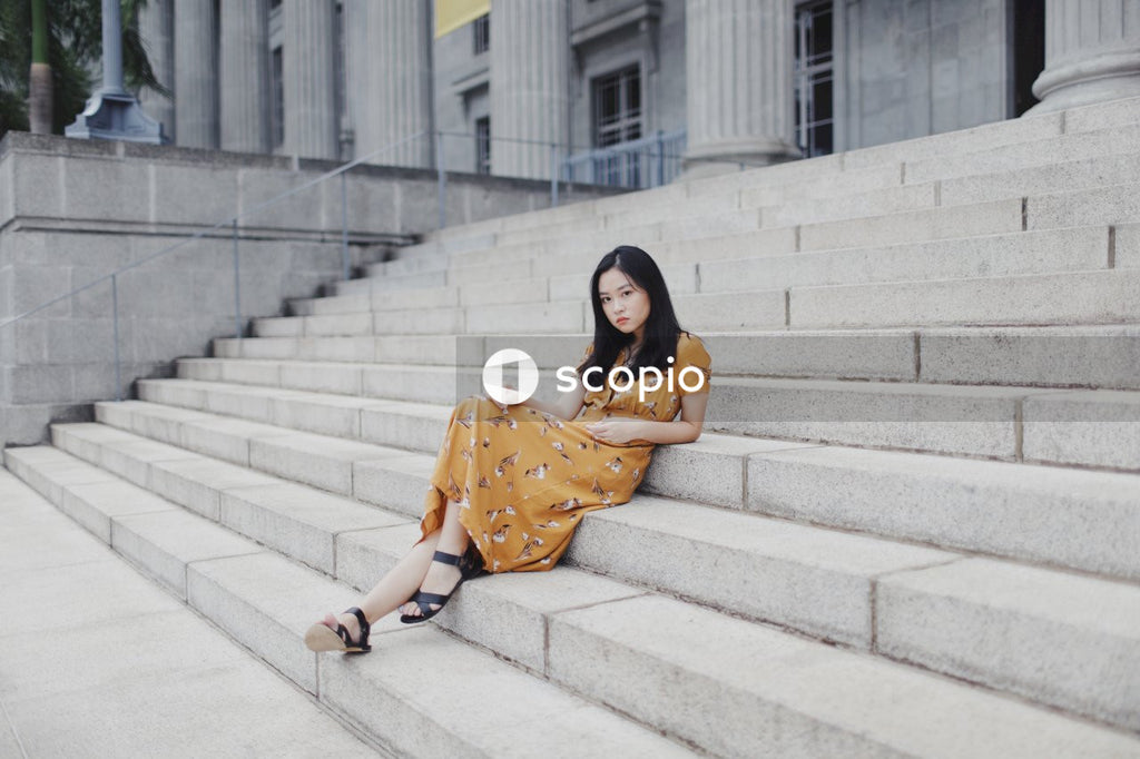 Woman in long orange dress on stairs