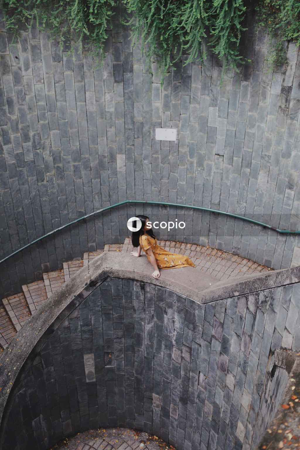 Woman in long orange dress on stairs