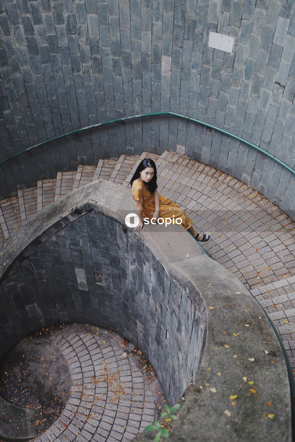 Woman in long orange dress on stairs