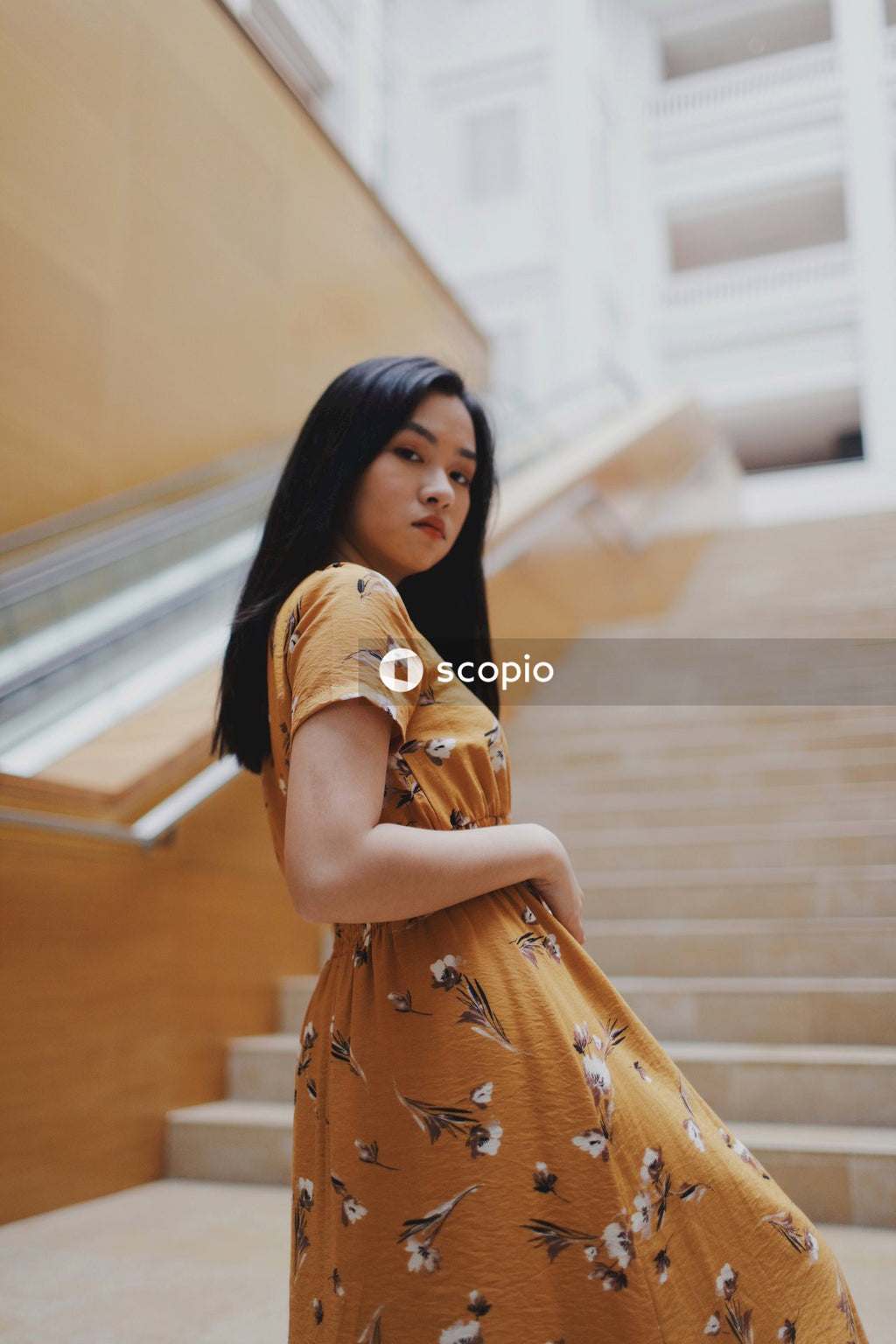 Woman in long orange dress on stairs