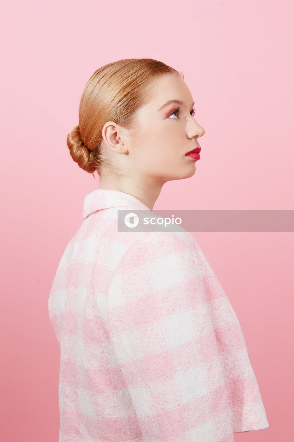 Woman in pink and white checkered dress shirt