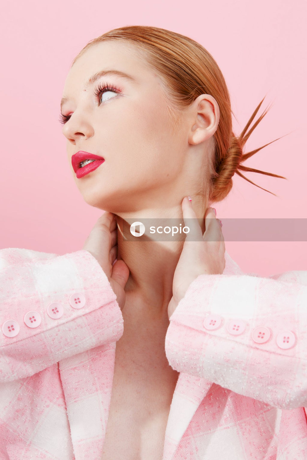 Woman in pink lipstick holding white textile