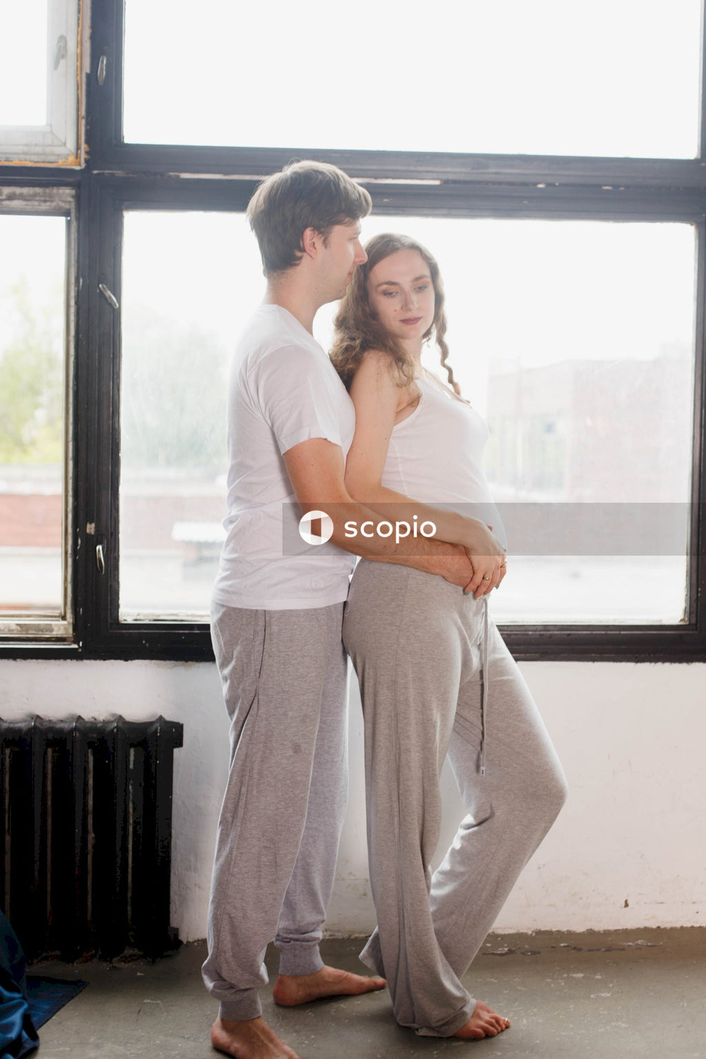 Woman in pink shirt hugging man in white t-shirt