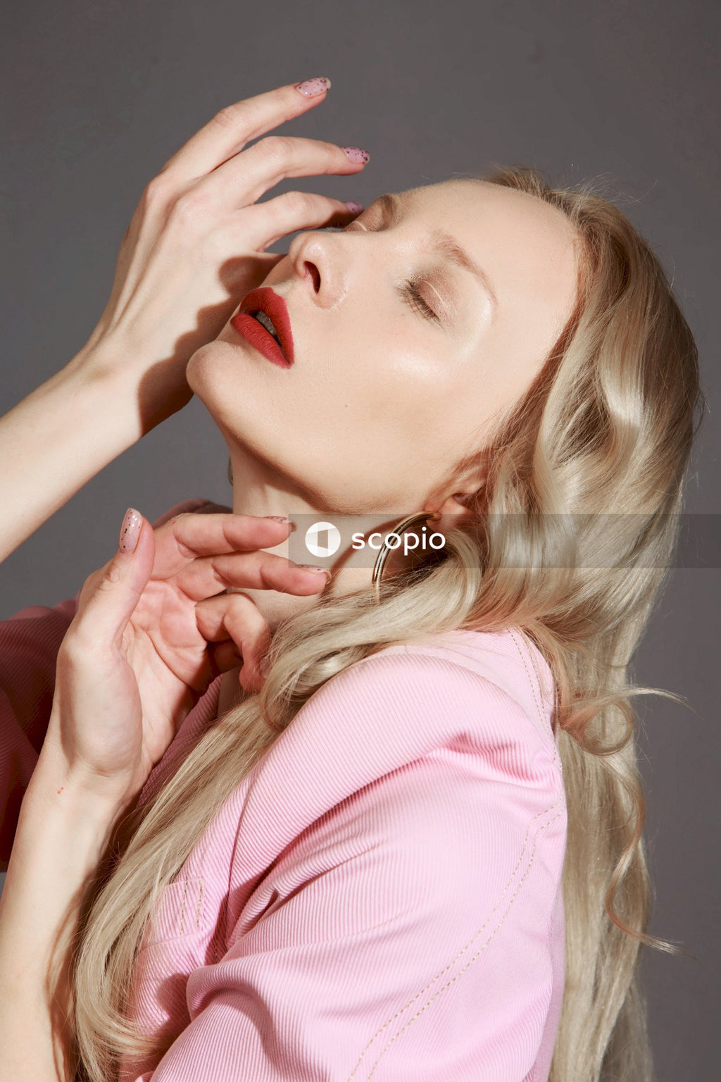 Woman in pink shirt with red lipstick