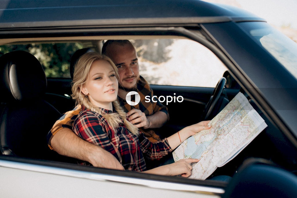 Man and woman in car using map