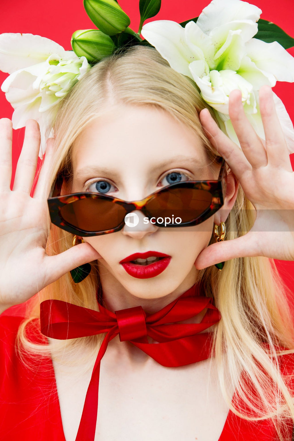Woman in red and white bow tie and black sunglasses