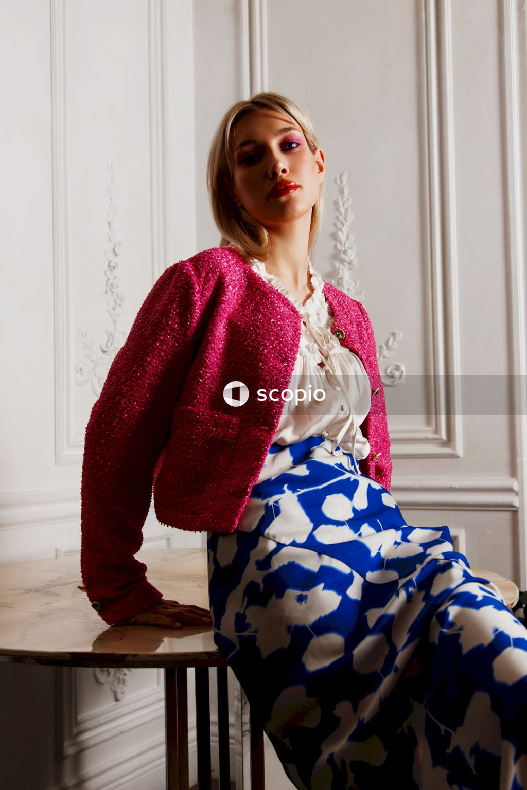 Woman in red cardigan and blue and white floral dress
