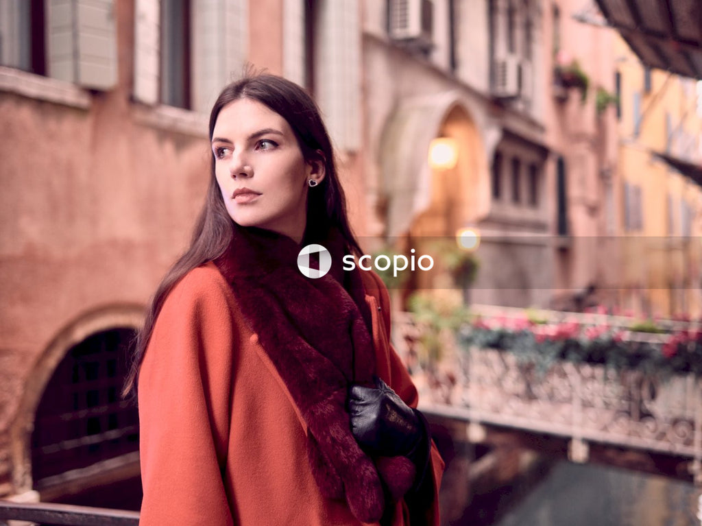Woman in red scarf and red coat standing on street in Venice, Italy